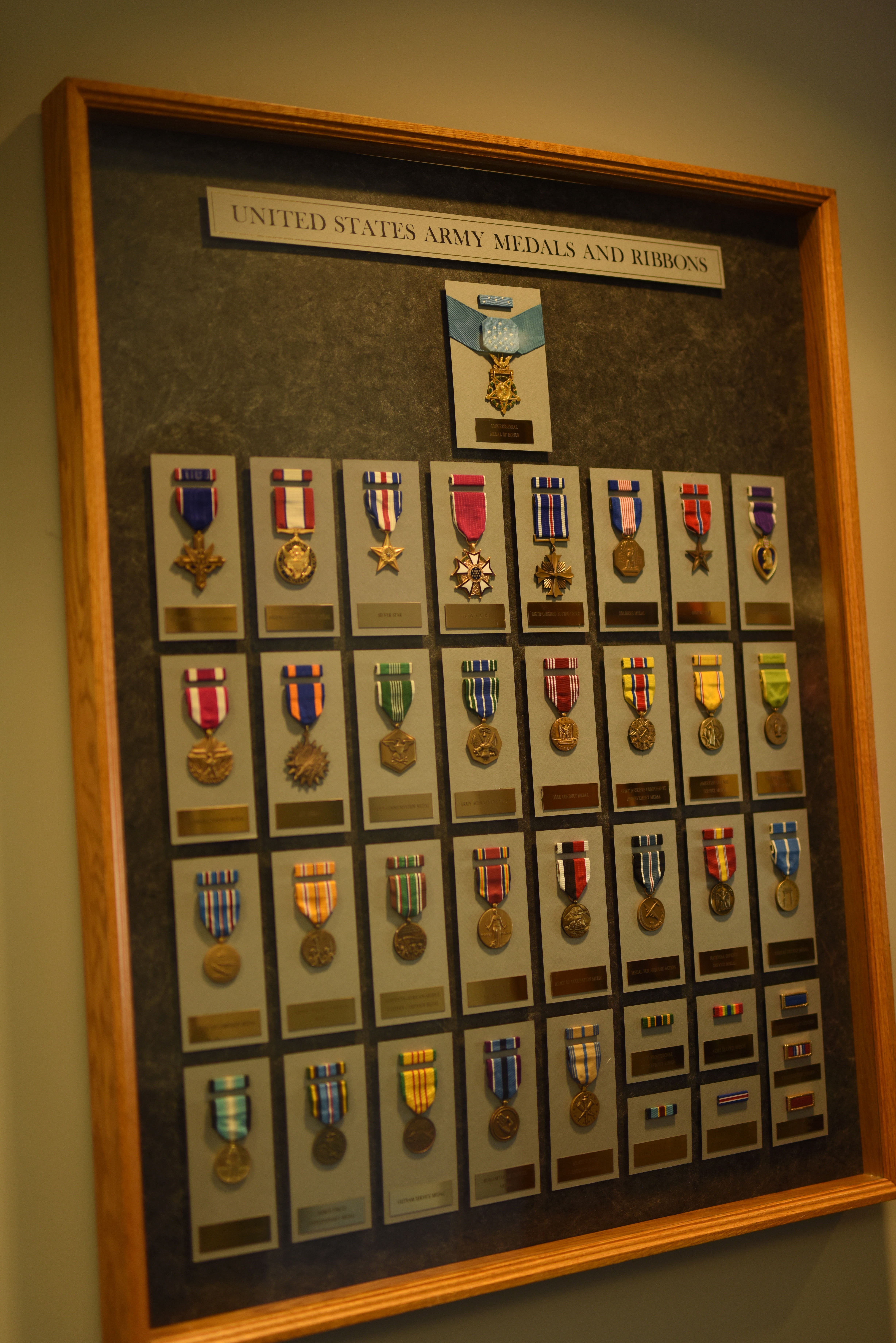 US army medals and ribbons in a shelf