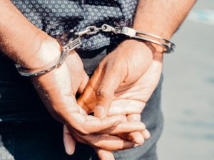 Person's hands handcuffed behind their back during a sexual assault arrest in Omaha | Berry Law
