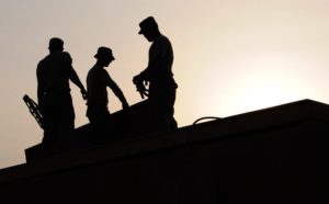 silhouette of three people with tools being trafficked for labor in Omaha | Berry Law