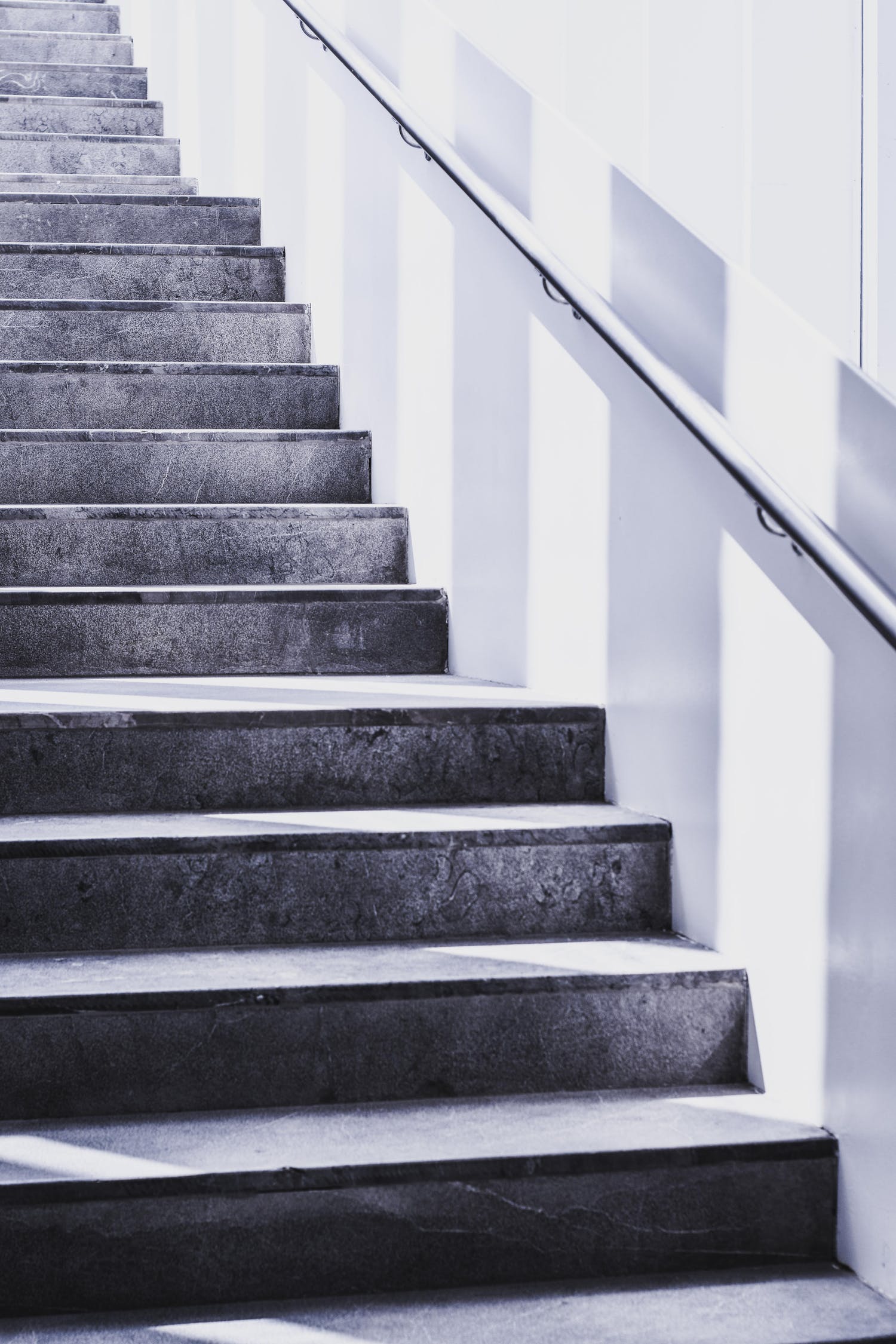 A concrete staircase with a handrail | Omaha | Berry Law