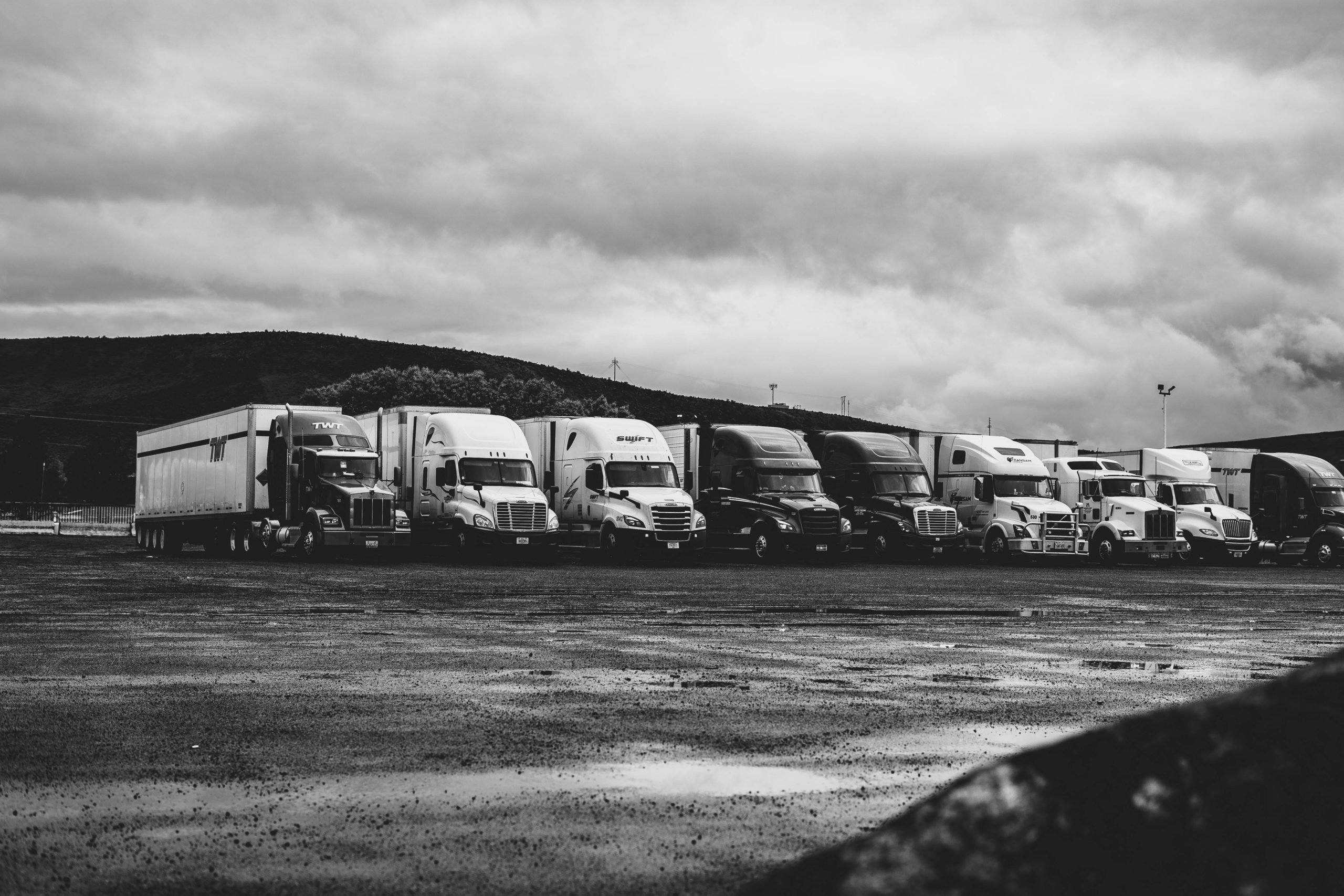 Black and white photo of a row of trucks | Berry Law | Omaha