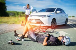 bicyclist on the ground after an accident with car