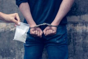 Drug dealer under arrest confined with handcuffs 