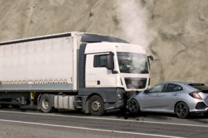 A head-on collision Between a car and a truck.