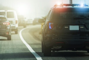 Police patrol cruiser on side of a road preparing to conduct a search warrant