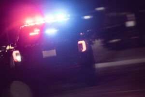 Police Cruiser with Flashing Lights at Night