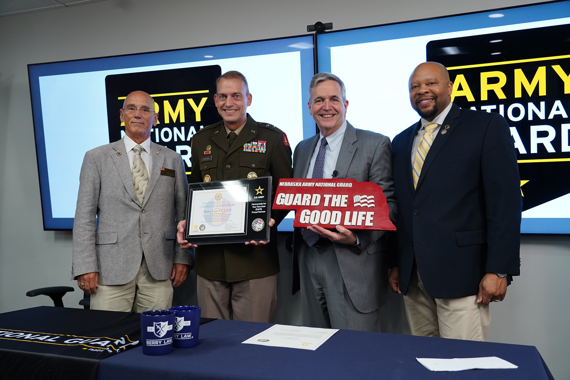 representatives from berry law and the army pays program standing together for a photo