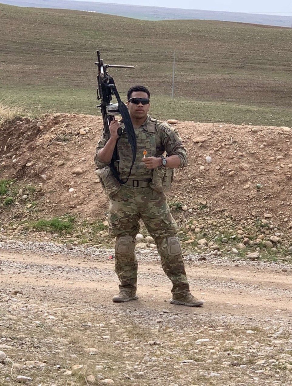 bobby burrell in military uniform holding a weapon